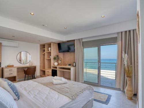 a bedroom with a large bed and a balcony at Starlight Ocean View in Kardamaina