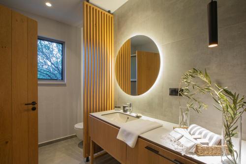 a bathroom with a sink and a mirror at Trioda Kazdağları in Ayvacık