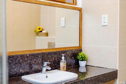 a bathroom with a sink and a mirror at Ocean view villa in Diani Beach