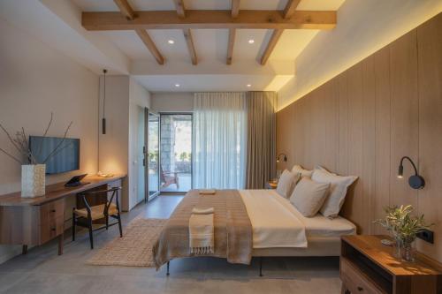 a bedroom with a large bed and a desk and a desk at Trioda Kazdağları in Ayvacık