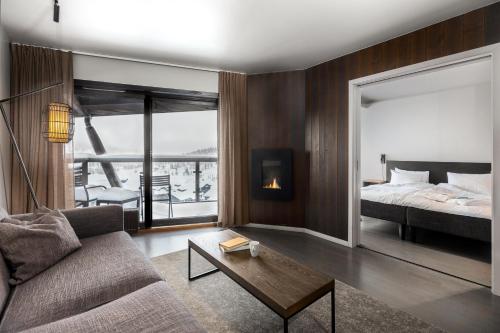 a living room with a bed and a couch at Norefjell Ski & Spa in Noresund