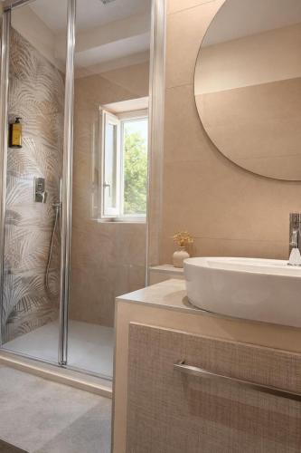 a bathroom with a sink and a shower at Il Ritrovo Rooms in Petralia Sottana
