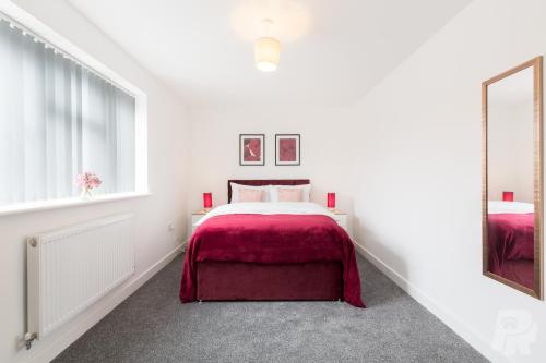 a white bedroom with a bed and a mirror at Birmingham Estate - Contractor & Group Accommodation - Secure Parking in Birmingham