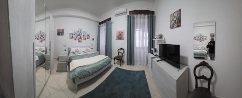a bedroom with a bed and a television in it at Il Viandante in Catanzaro