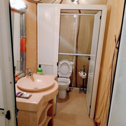 a bathroom with a sink and a toilet and a shower at Sunrise Dunes Luxury Camp in Merzouga