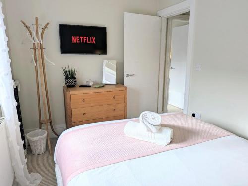 a bedroom with a bed with a towel on it at The Mews with free parking in York