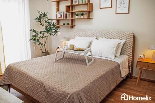 a bedroom with a bed with a tray on it at Zoi Suite - fully renovated luxury apartment in Chalkida
