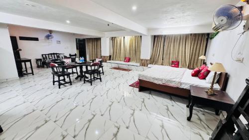 a large room with a bed and a table and chairs at HOTEL SHREE JMM s14 near by in Udaipur