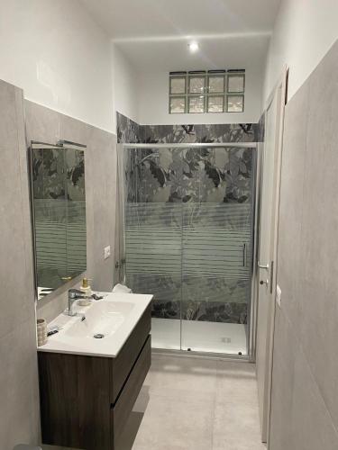 a bathroom with a sink and a shower at Kennedy rooms in Isernia