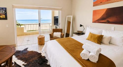 a bedroom with a large bed with a view of the ocean at Sunset View 10 @ Langstrand in Langstrand