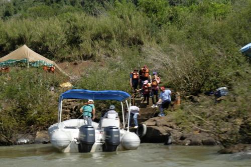 a group of people on a boat in the water at La Mision Mocona - Lodge de Selva in Saltos del Moconá