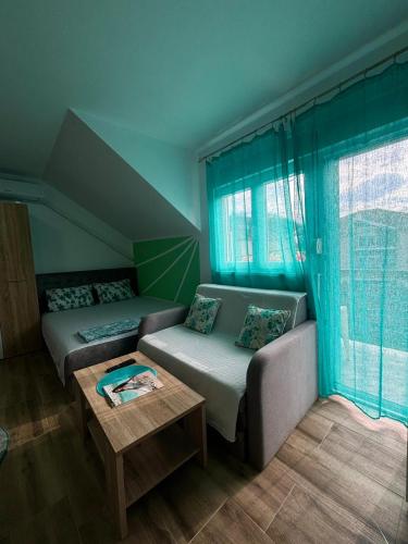 a living room with a couch and a table at Vila Mir Banja Vrujci in Gunjica
