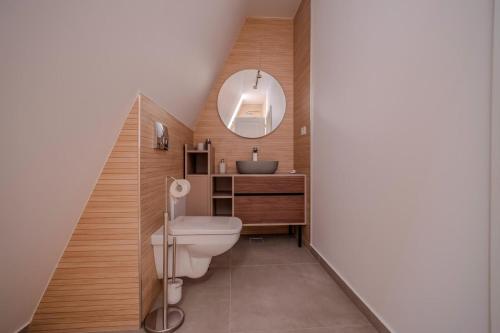 a bathroom with a toilet and a sink at Lotus 2 in Goruna