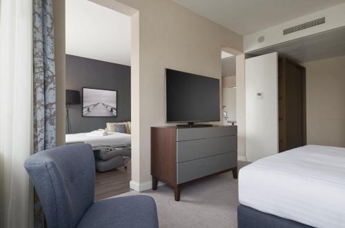a hotel room with a tv and a bed at Marriott Hotel The Hague in The Hague