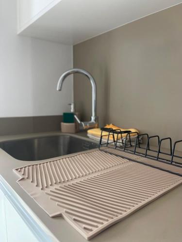 a metal drying rack on a kitchen counter at Coração d`Alice in Monção