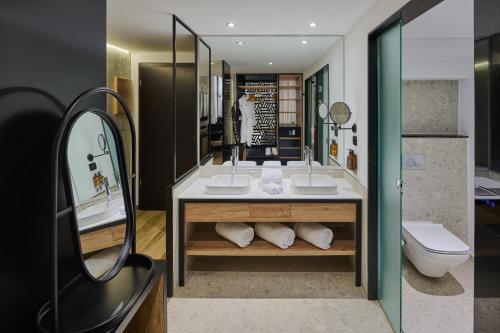 a bathroom with two sinks and a toilet at Steigenberger Aldau Beach Hotel in Hurghada