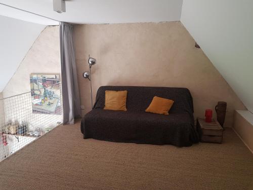a bedroom with a bed with two pillows on it at L'Oisiveraie - Ecolieu dans le bocage normand in Dompierre