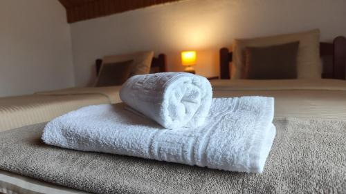 a stack of towels sitting on top of a bed at Nest for rest in Mojkovac
