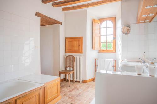 a kitchen with a sink and a bath tub at Château du Hardas in Segré