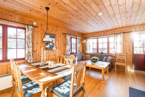 a living room with a table and a couch at Rauland Feriesenter in Rauland