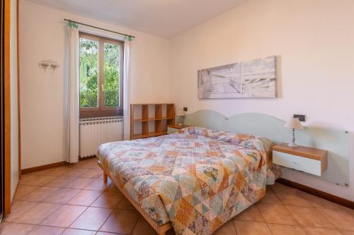 a bedroom with a bed and a window at TINA HOME LAKE VIEW in Garda