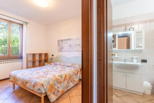 a bedroom with a bed and a sink at TINA HOME LAKE VIEW in Garda