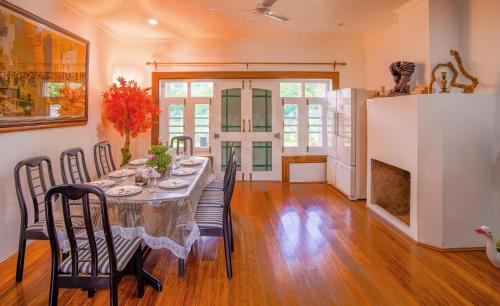 a dining room with a long table and chairs at Gaash Cottages in Buna Palang