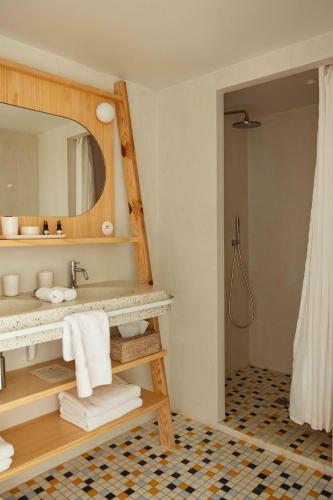 a bathroom with a sink and a mirror at Hotel des Dunes in Cap-Ferret
