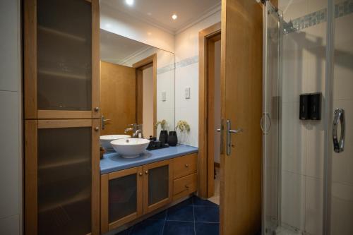 a bathroom with a sink and a shower at Mellieha Bay 3 Bedroom Apartment ''Coastal Comfort'' in Mellieħa