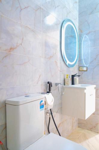 a bathroom with a white toilet and a mirror at perle de dakhla in Dakhla