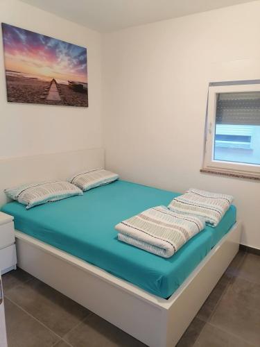 a bed in a room with a blue mattress at Holiday Park Mimoza in Bašanija