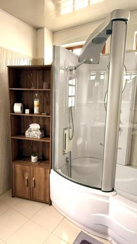 a bathroom with a shower with a glass door at Hotel Boutique Villa Mercedes in Sopó
