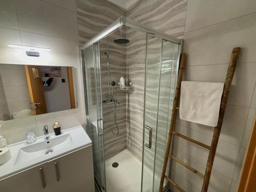 a bathroom with a shower and a sink at Al Mare Ocean View in Albufeira
