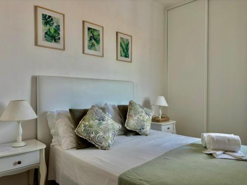 a bedroom with a white bed with pillows on it at Al Mare Ocean View in Albufeira