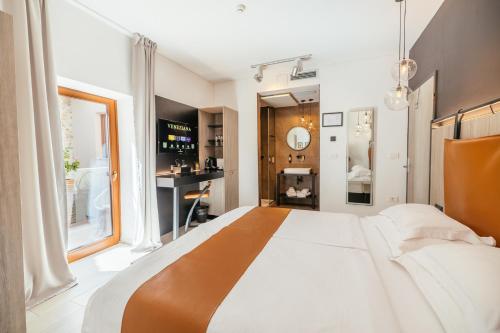 a bedroom with a large bed and a window at VENEZIANA Boutique Hotel Superior in Koper