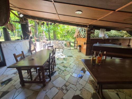 a patio with a table and chairs and a piano at Chalet de la vallée in Souppes-sur-Loing