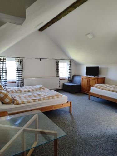 a large room with two beds and a couch at U Vaclava in Hřensko