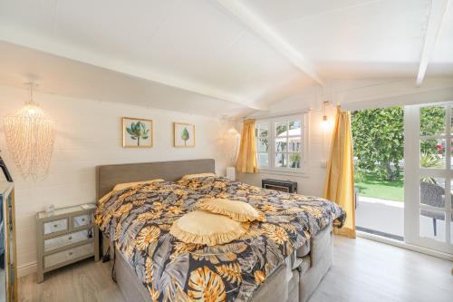 a bedroom with a bed and a large window at Casa Caro in Estepona