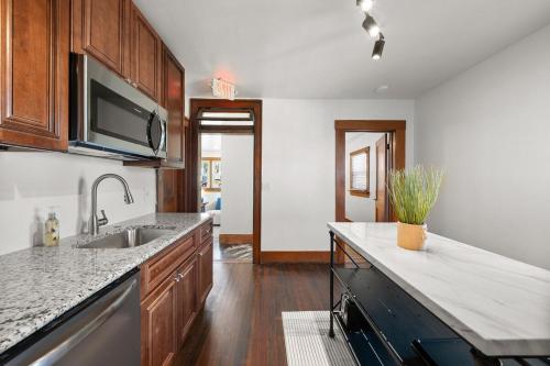 a kitchen with a sink and a counter top at The Barker Bungalow in St. Charles