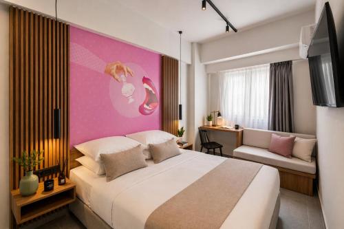 a hotel room with a bed and a couch at The Q Hotel in Athens