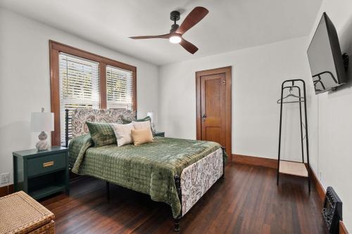 a bedroom with a bed and a ceiling fan at The Barker Bungalow in St. Charles