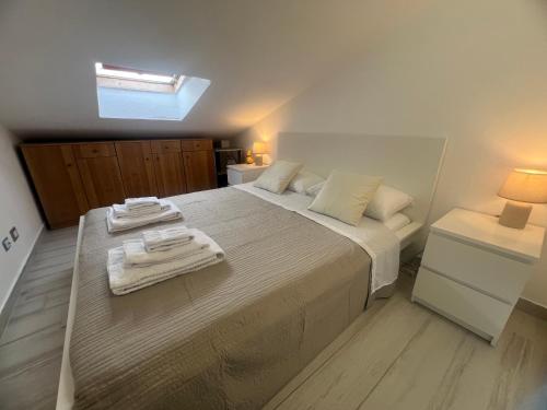 a bedroom with a large bed with towels on it at Santicelli 12 in Soverato Marina