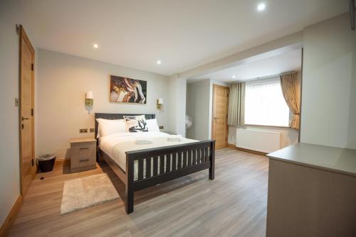a bedroom with a large bed and a window at Hazel Lodge in Reading