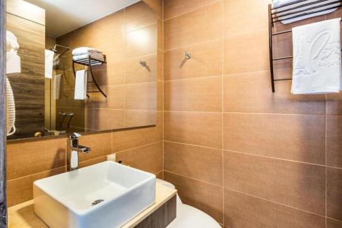 a bathroom with a sink and a toilet at Hotel American Blessing in Bogotá