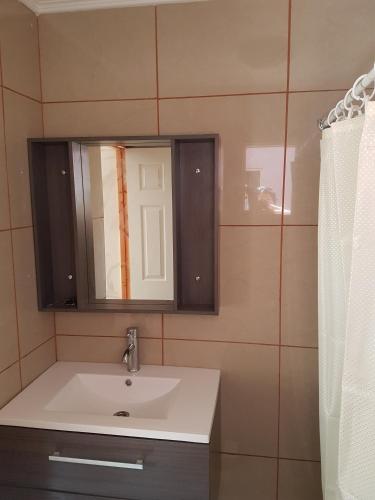 a bathroom with a sink and a mirror at Vicuña Lodge in San Pedro de Atacama