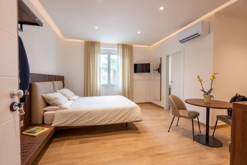 a hotel room with a bed and a table at Dante Suites in Pergola