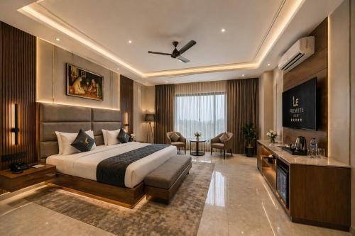 a hotel room with a bed and a television at Hotel Eden Suites Delhi Airport in New Delhi