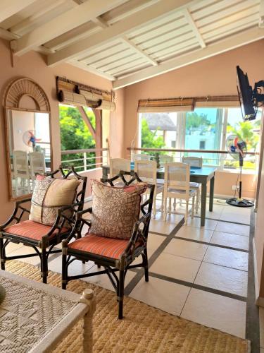 a living room with chairs and a table at CosyNest Apartment in Cap Malheureux