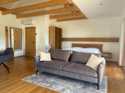 a living room with a couch and a bed at Weinloft Gamlitz in Gamlitz