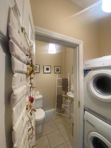 a bathroom with a toilet and a washing machine at 4 Bed in Derrylin oc-k35059 in Derrylin